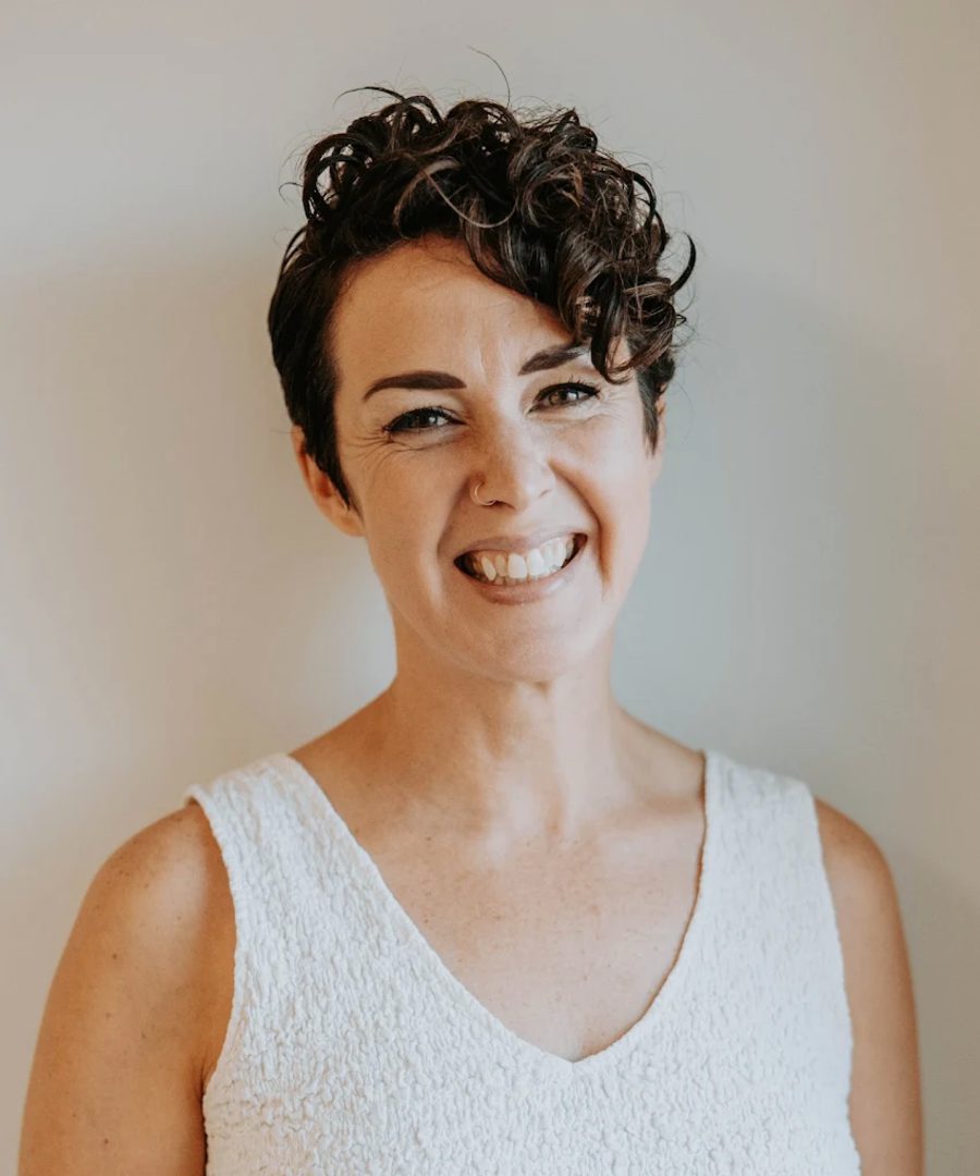 Joy Wawrzyniak, LCSW, smiling, in a white top.