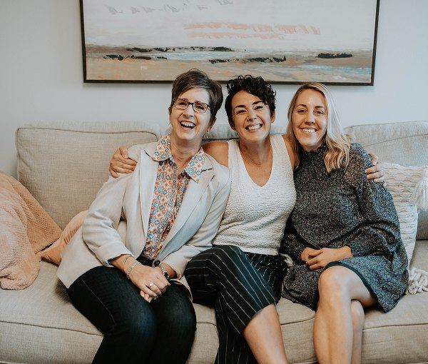 The Willow Tree Mental Health team sitting together on a sofa in the Exton office.